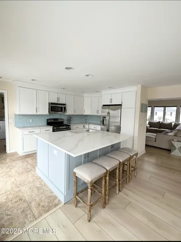 a large kitchen with a table and chairs