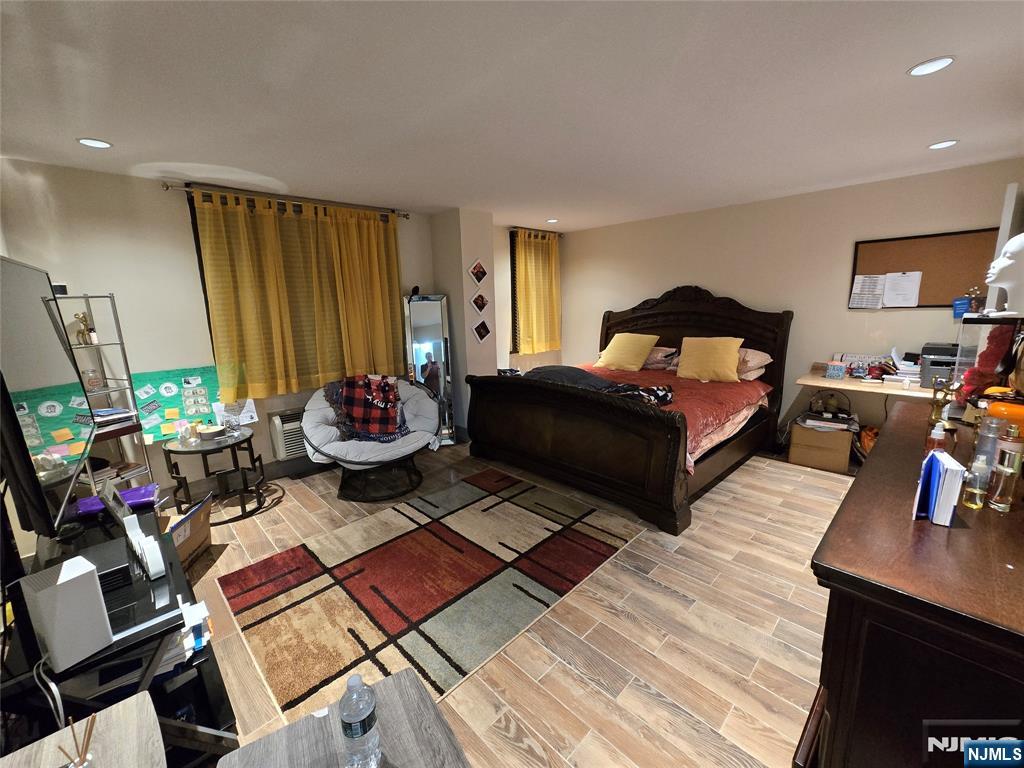 a bedroom with furniture and a flat screen tv