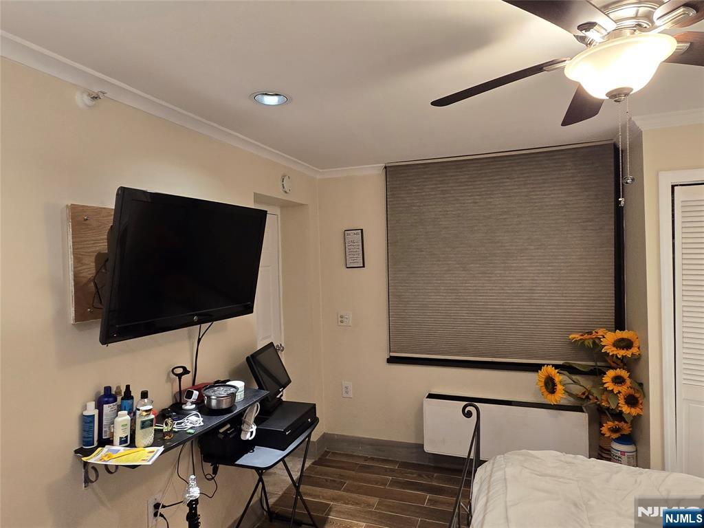 326 Prospect Avenue, Unit 1A Hackensack, NJ 07601 - Photo 11 of 19 a living room with furniture and a flat screen tv