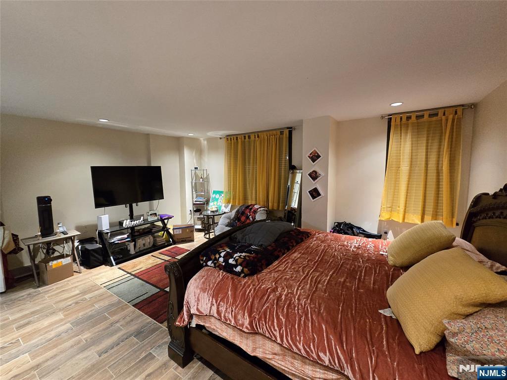 326 Prospect Avenue, Unit 1A Hackensack, NJ 07601 - Photo 2 of 19 a bedroom with bed tv and window
