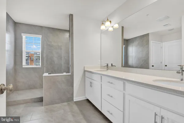 a bathroom with a sink mirror and a bathtub