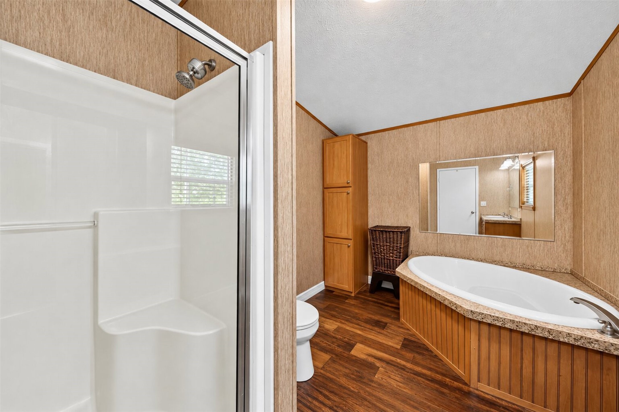 2581 Mann Road Conroe, TX 77303 - Photo 21 of 32 Full bathroom featuring a tub/shower combination, vanity, and warm wood cabinetry.