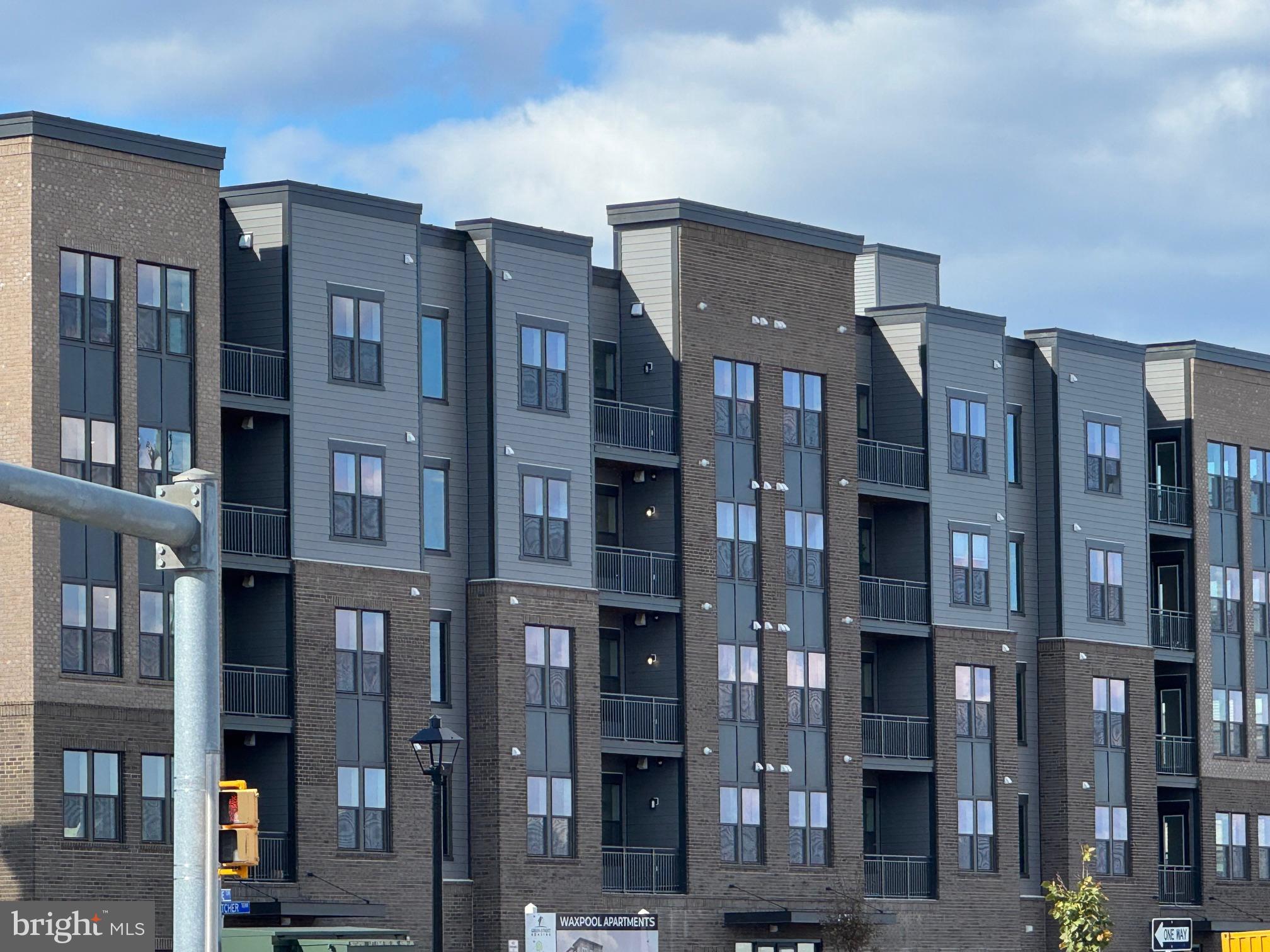21731 Dovekie Terrace, Unit 408 Ashburn, VA 20147 - Photo 1 of 20 a front view of a building with glass windows