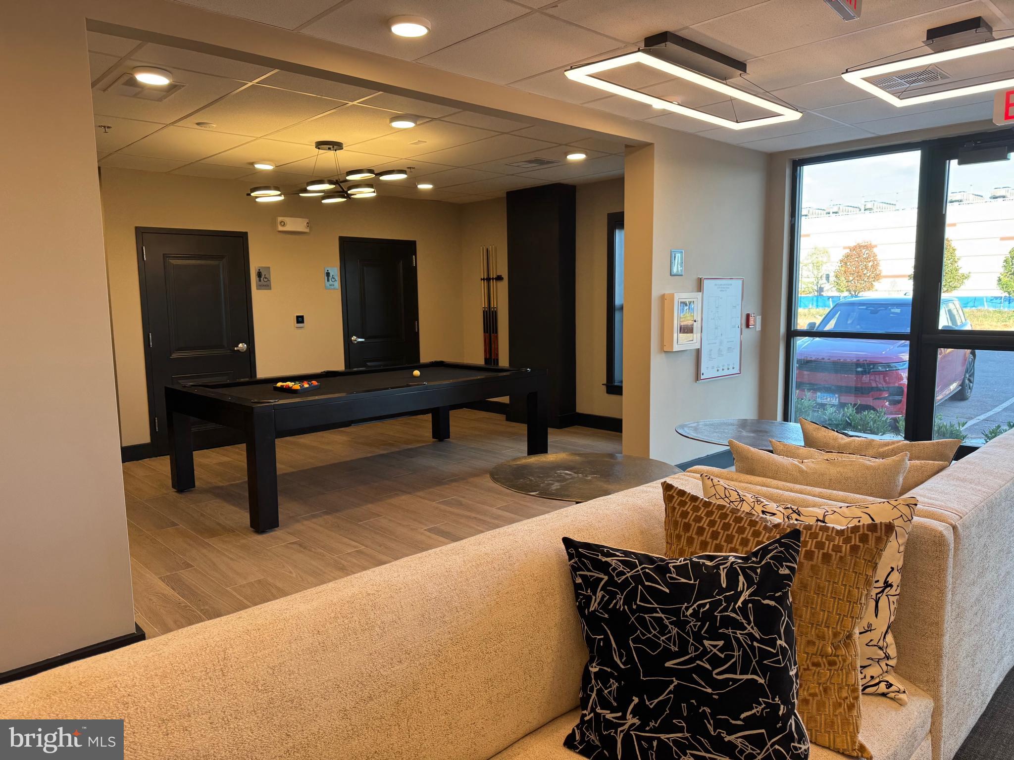 21731 Dovekie Terrace, Unit 408 Ashburn, VA 20147 - Photo 17 of 20 a bed room with a bed and a chandelier