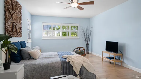 a bedroom with furniture and a flat screen tv