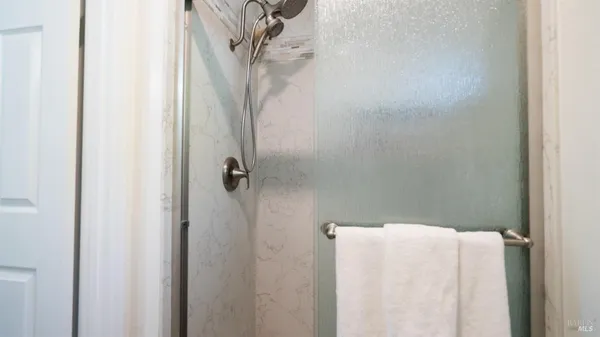 a bathroom with a granite countertop sink a toilet and a mirror