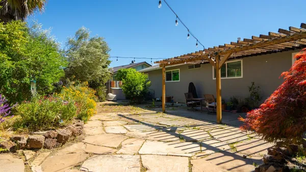 a view of a backyard with plants and a patio