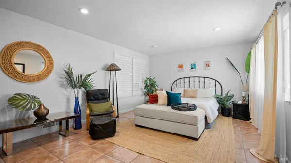 a living room with furniture flowerpot and a window