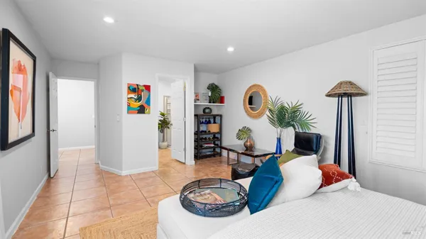 a view of bathroom with a potted plant on a sink and a wooden floor