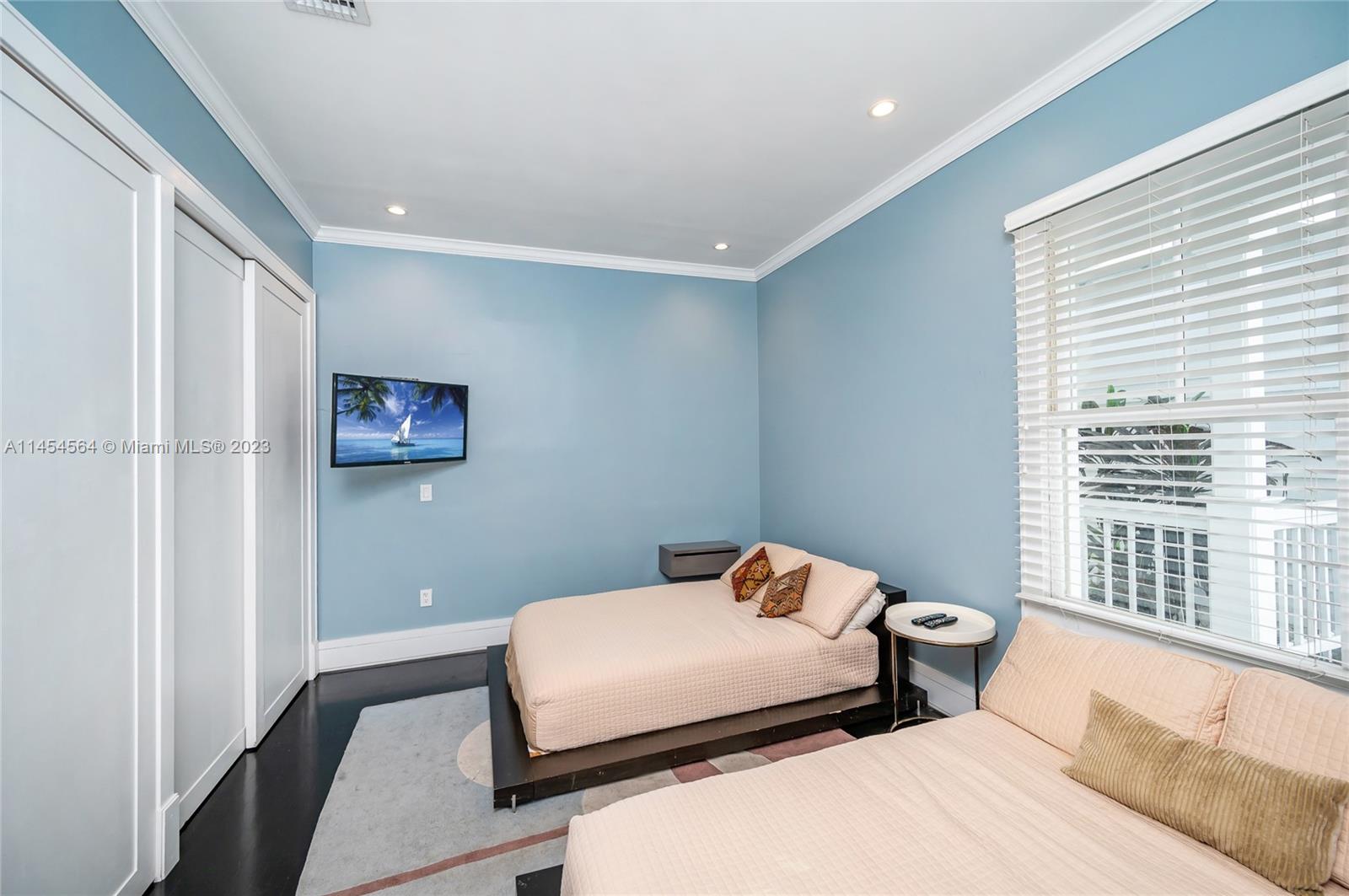 8325 School House Road Miami, FL 33143 - Photo 11 of 21 a bedroom with a bed and a large window