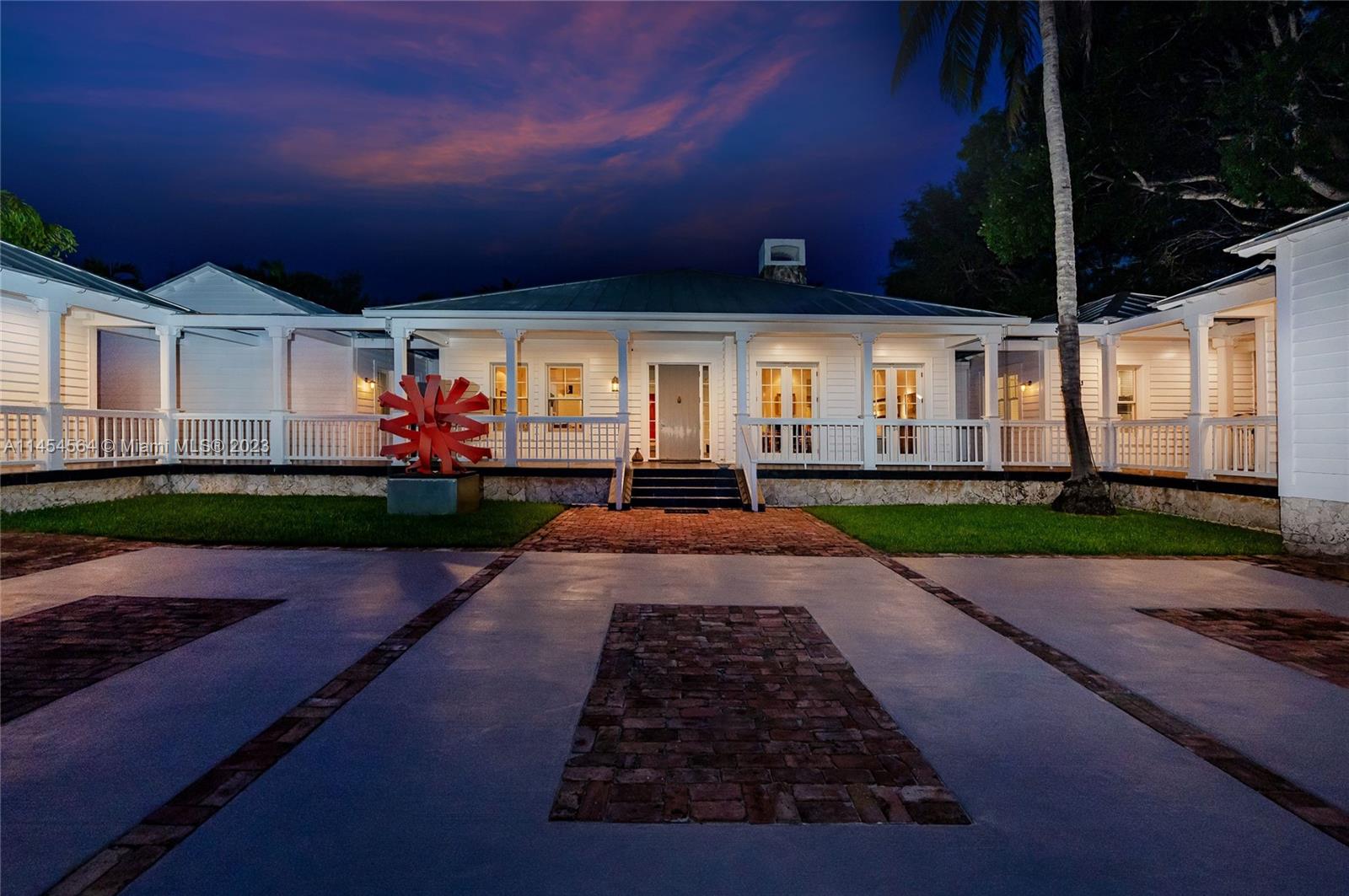 8325 School House Road Miami, FL 33143 - Photo 2 of 21 a front view of a house with a yard and garage