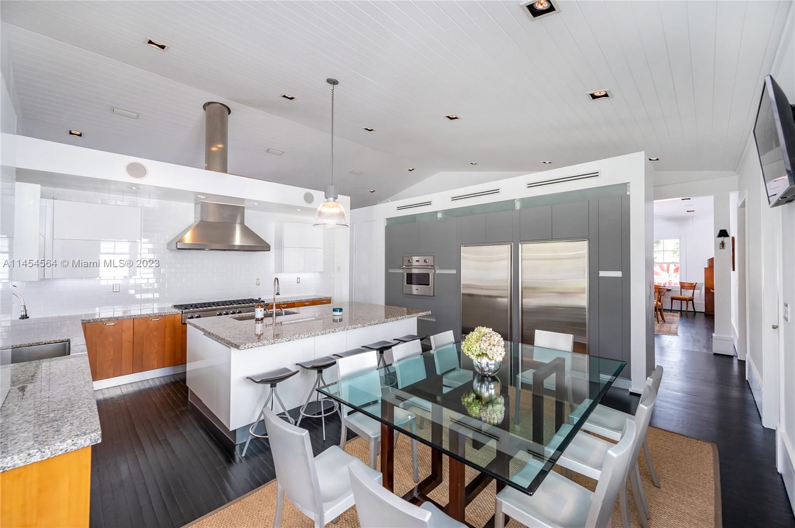 8325 School House Road Miami, FL 33143 - Photo 7 of 21 a very nice looking open dining room with kitchen island stainless steel appliances a table and chairs