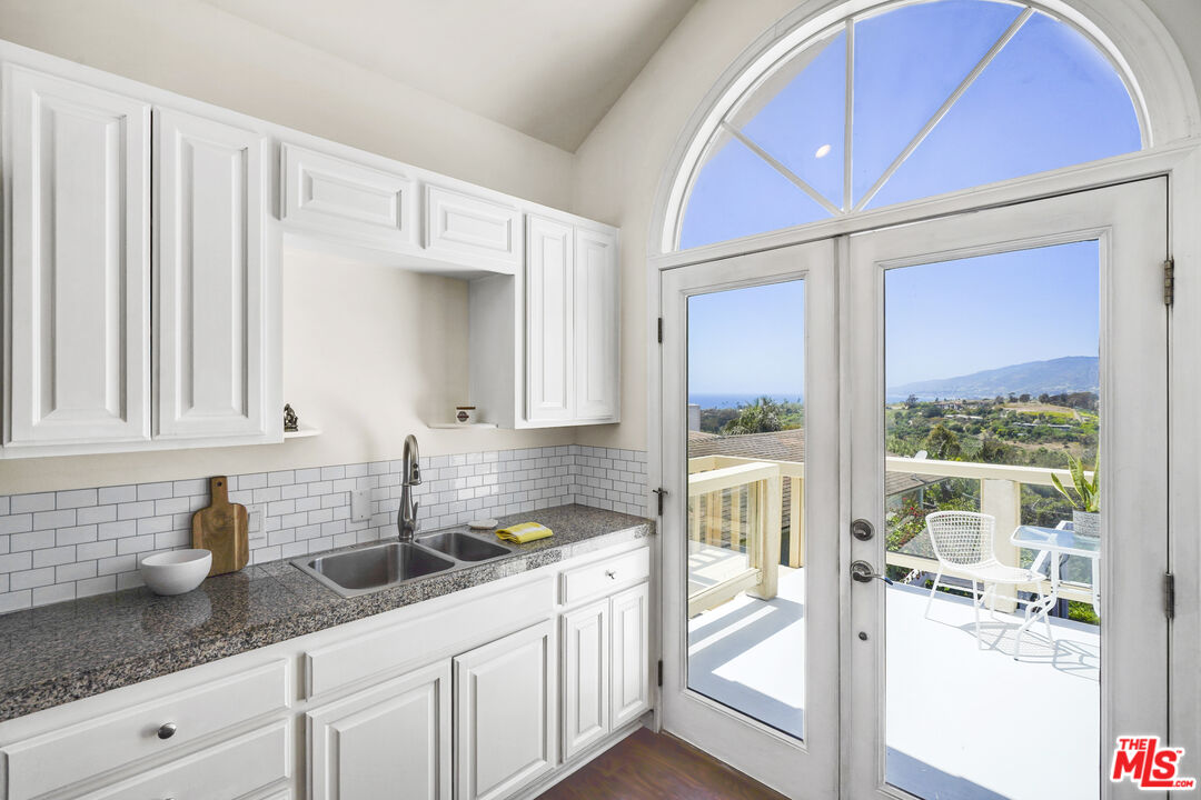 29355 Heathercliff Road, Unit GUESTHOUSE Malibu, CA 90265 - Photo 1 of 26 a kitchen with sink and cabinets