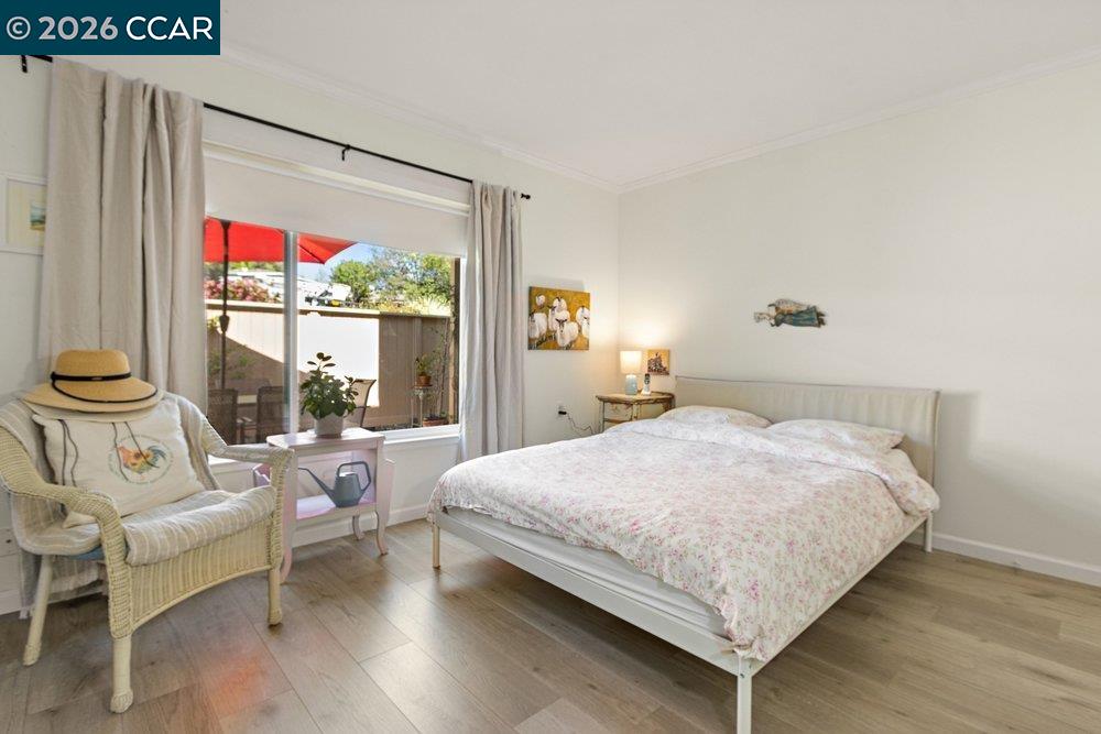 2001 Golden Rain Road, Unit 4 Walnut Creek, CA 94595 - Photo 22 of 60 a bedroom with a bed and large window