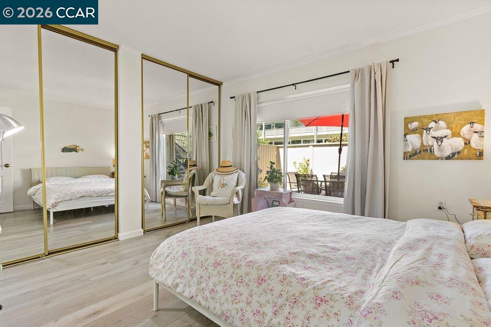 2001 Golden Rain Road, Unit 4 Walnut Creek, CA 94595 - Photo 23 of 60 a bedroom with a large bed and a large window
