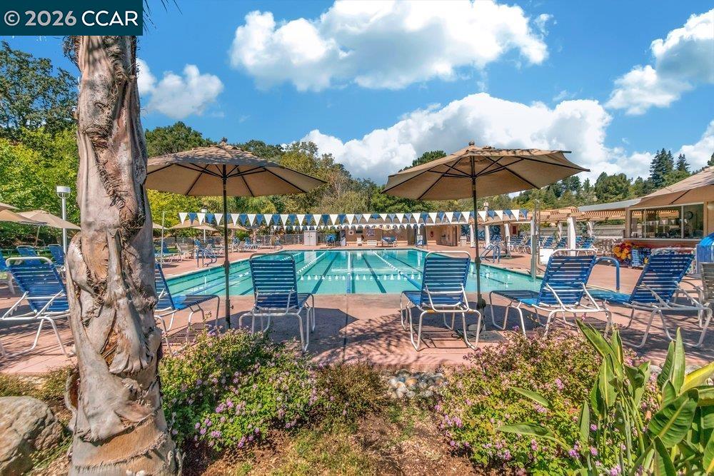 2001 Golden Rain Road, Unit 4 Walnut Creek, CA 94595 - Photo 48 of 60 a view of a chairs and table under an umbrella in the backyard