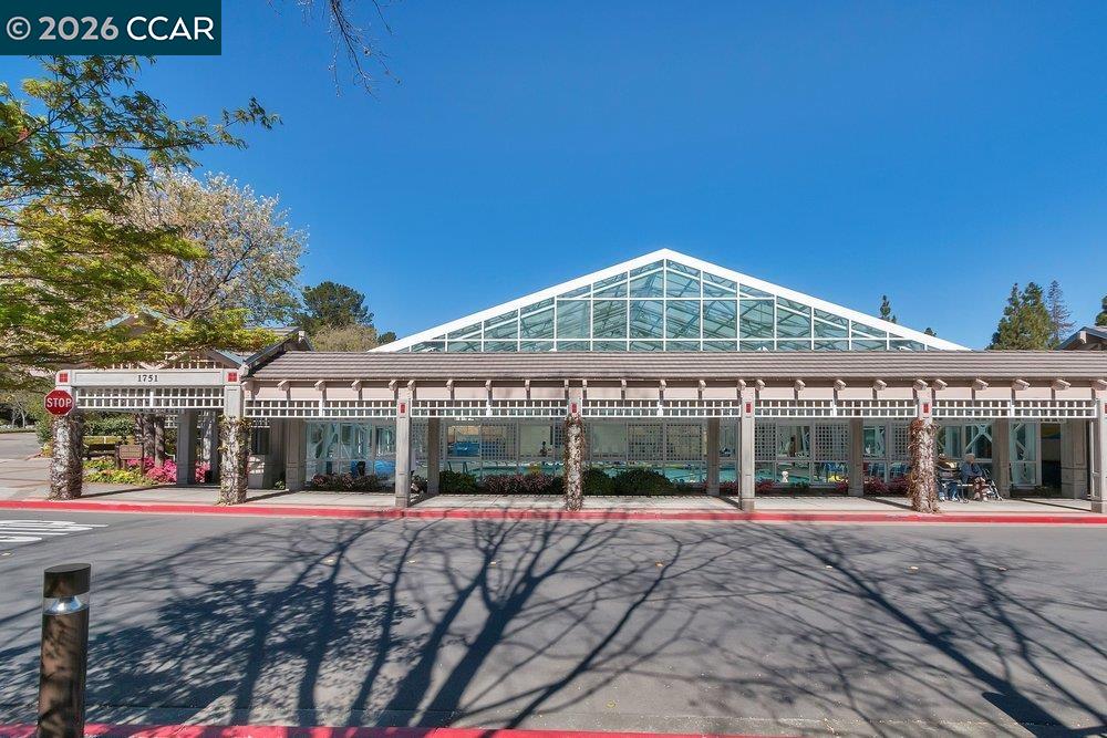 2001 Golden Rain Road, Unit 4 Walnut Creek, CA 94595 - Photo 56 of 60 a view of a white house with a large windows and palm trees