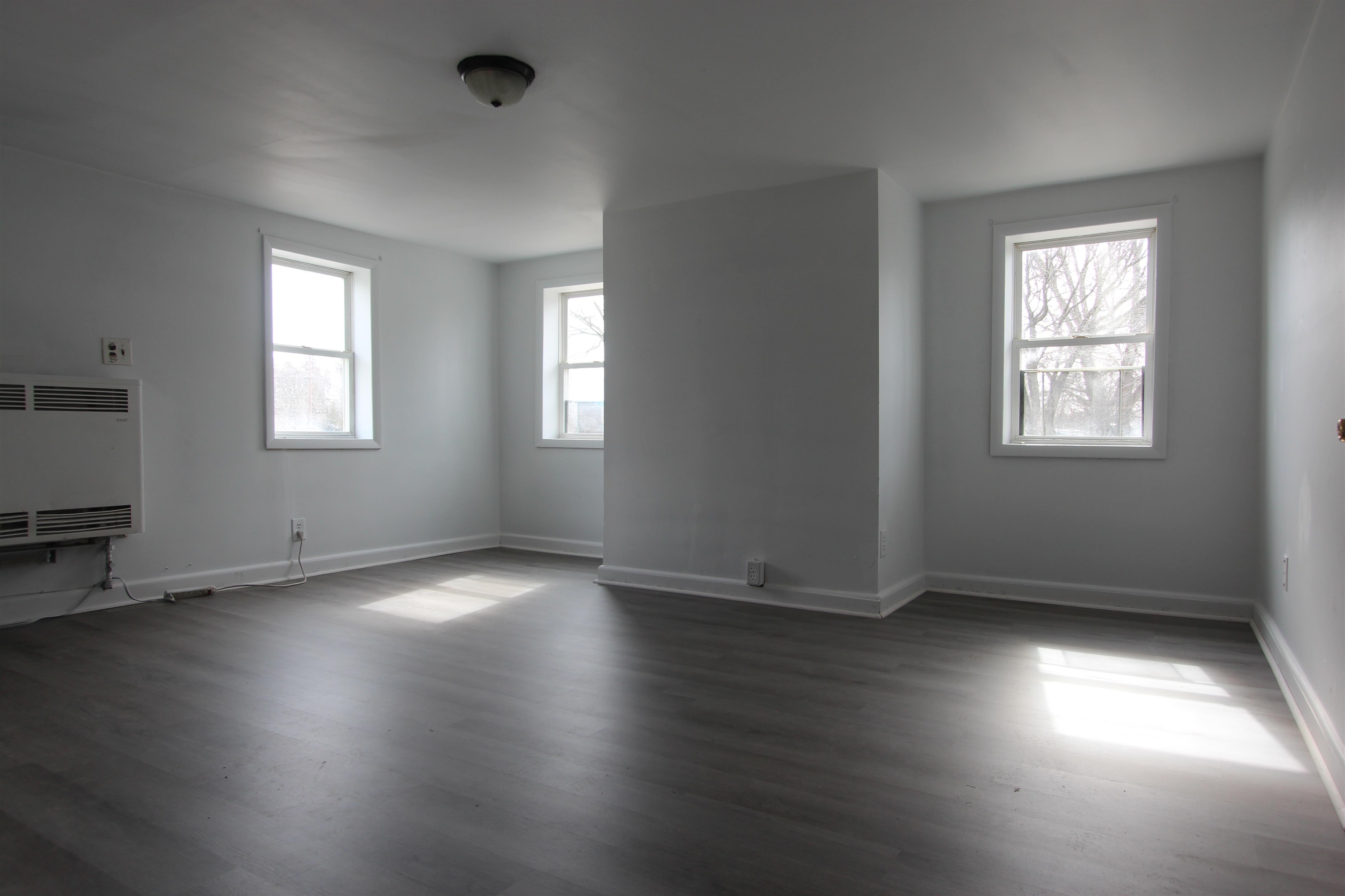 597 Seashore Road Erma, NJ 08204 - Photo 7 of 31 an empty room with wooden floor and windows