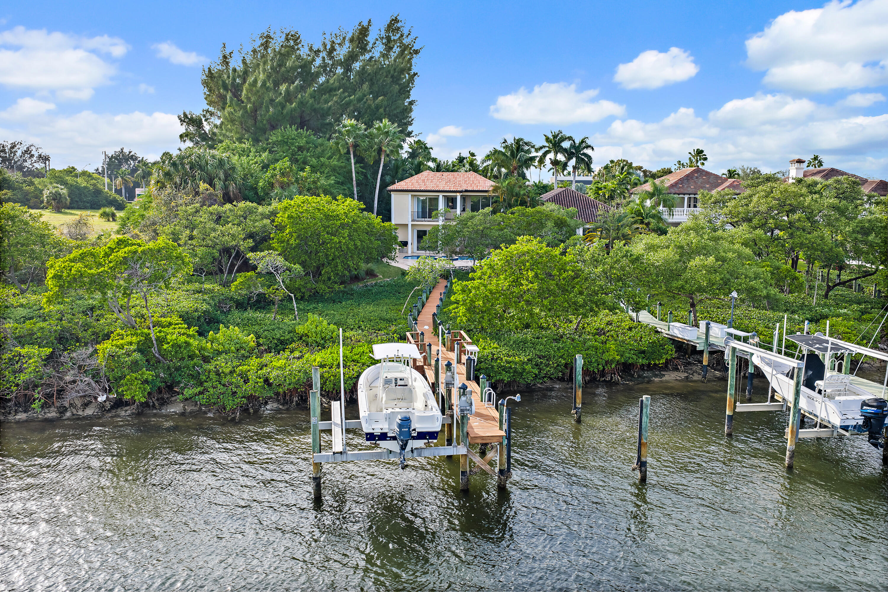 111 Fishermans Way Jupiter, FL 33477 - Photo 1 of 57 a view of a wooden house with a yard and sitting area