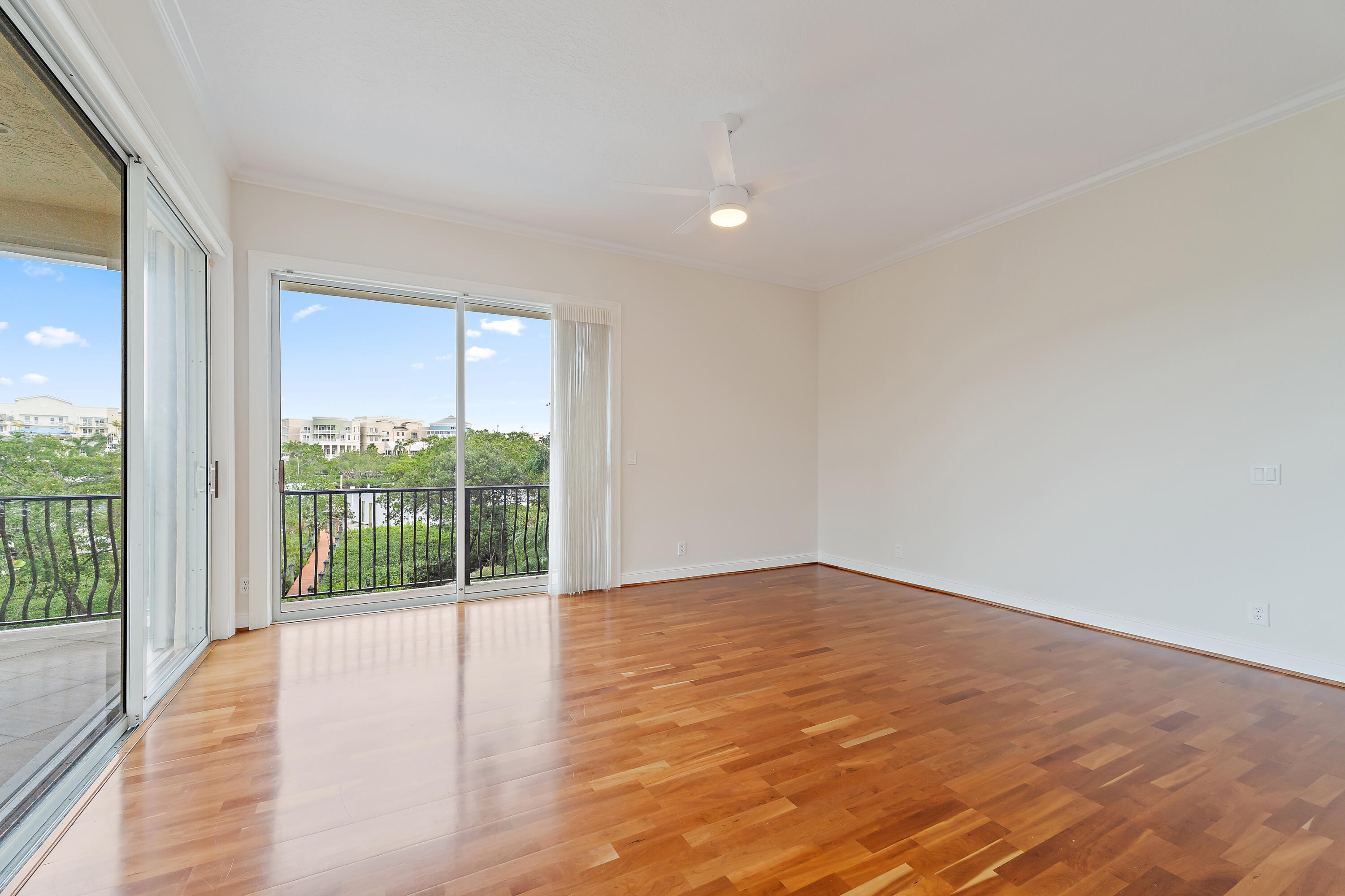 111 Fishermans Way Jupiter, FL 33477 - Photo 30 of 57 a view of an empty room with wooden floor and a window