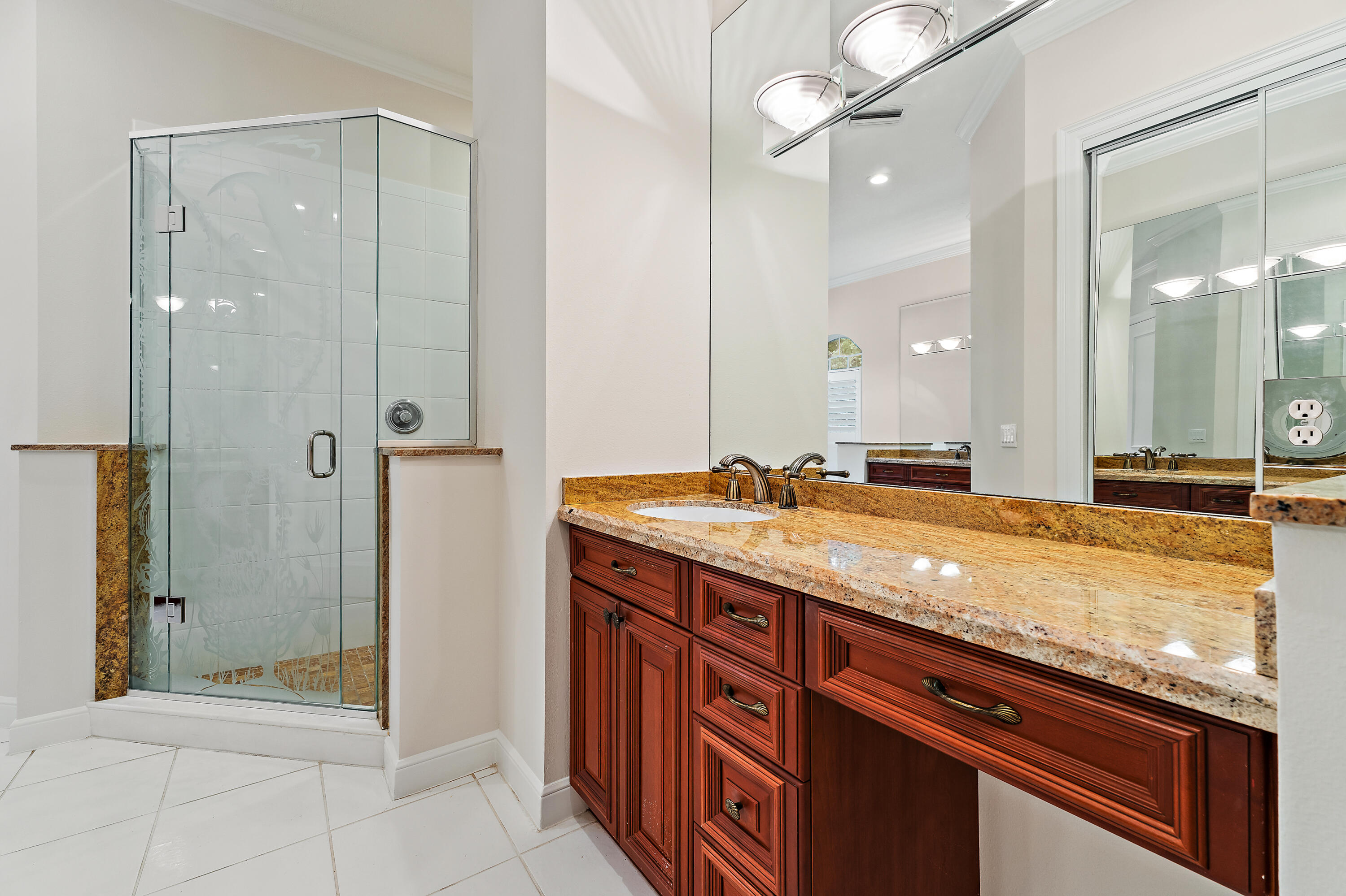 111 Fishermans Way Jupiter, FL 33477 - Photo 34 of 57 a bathroom with a granite countertop sink a mirror and a shower
