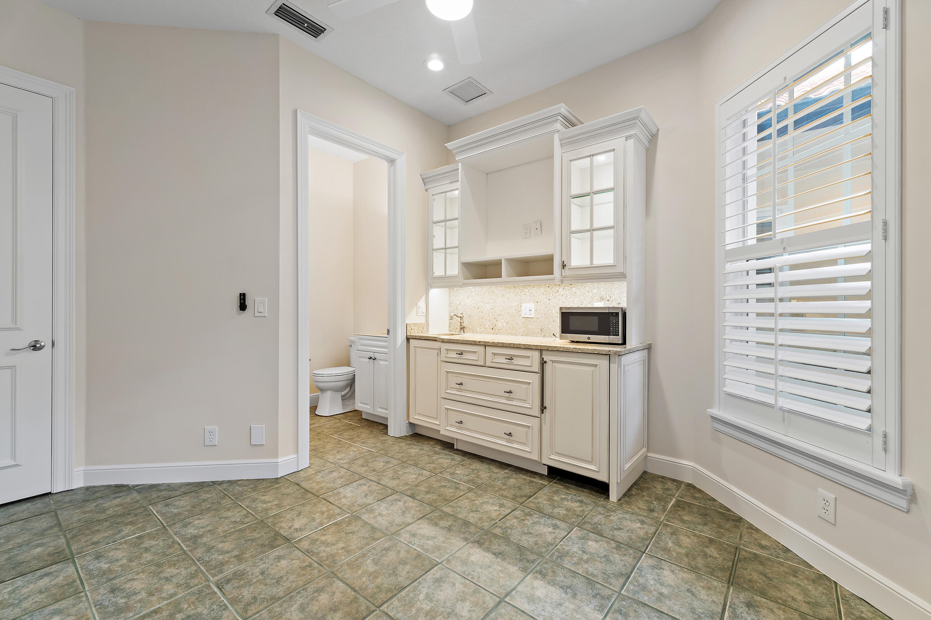 111 Fishermans Way Jupiter, FL 33477 - Photo 47 of 57 a room with a dresser and a window