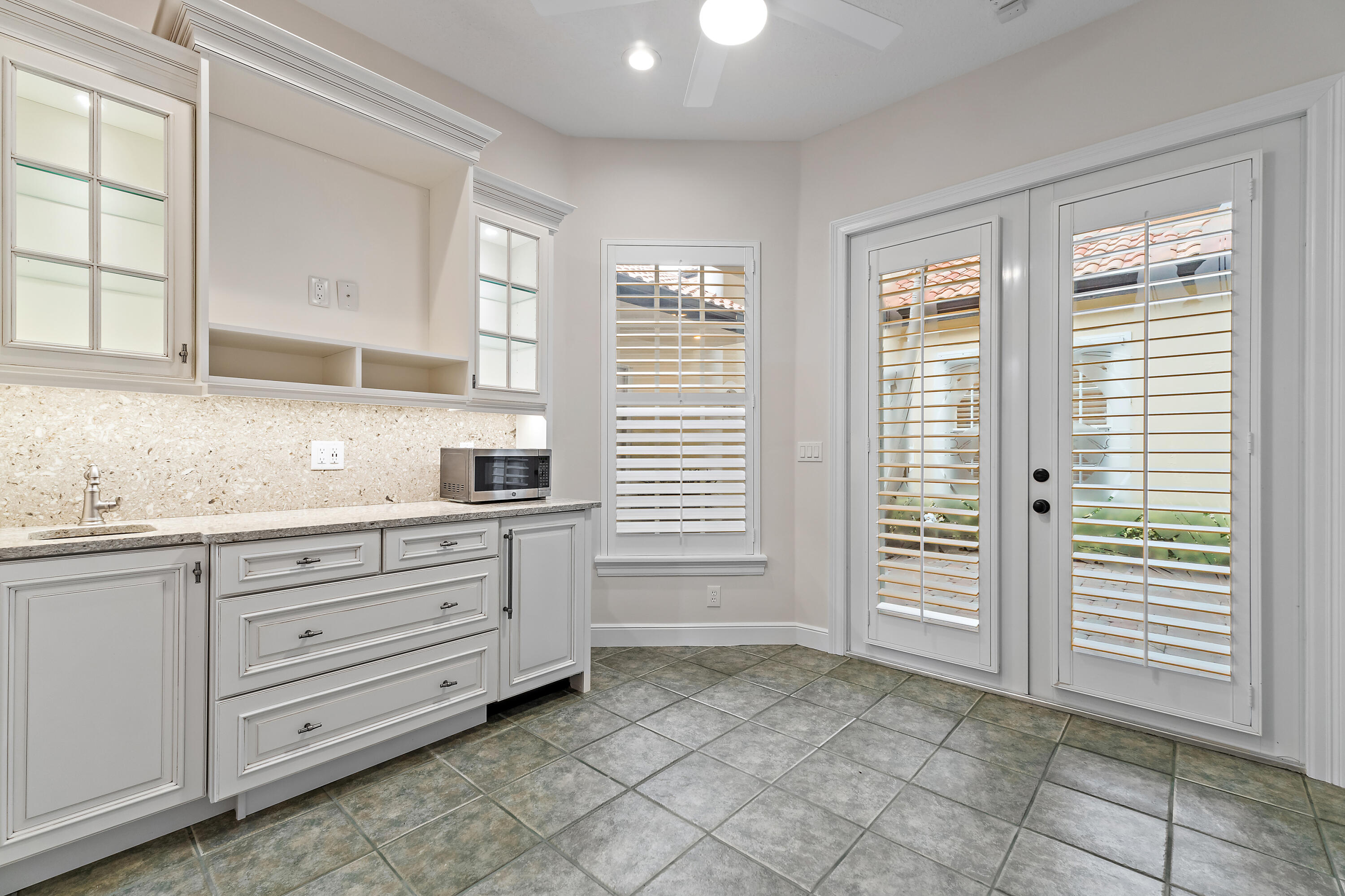 111 Fishermans Way Jupiter, FL 33477 - Photo 48 of 57 a kitchen with granite countertop a sink and cabinets