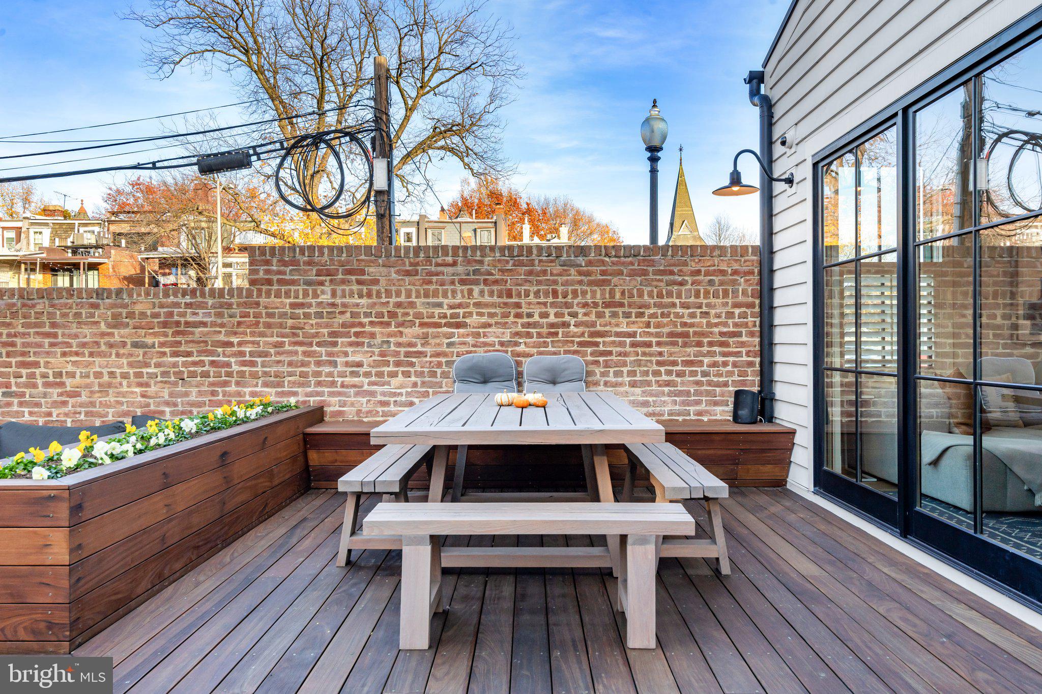 214 A Street Northeast Washington, DC 20002 - Photo 20 of 78 a view of a balcony with wooden floor and outdoor seating