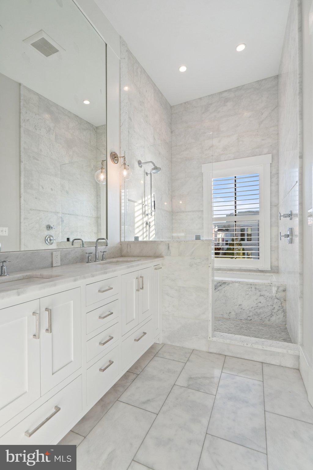 214 A Street Northeast Washington, DC 20002 - Photo 34 of 78 a bathroom with a granite countertop sink a mirror and a shower