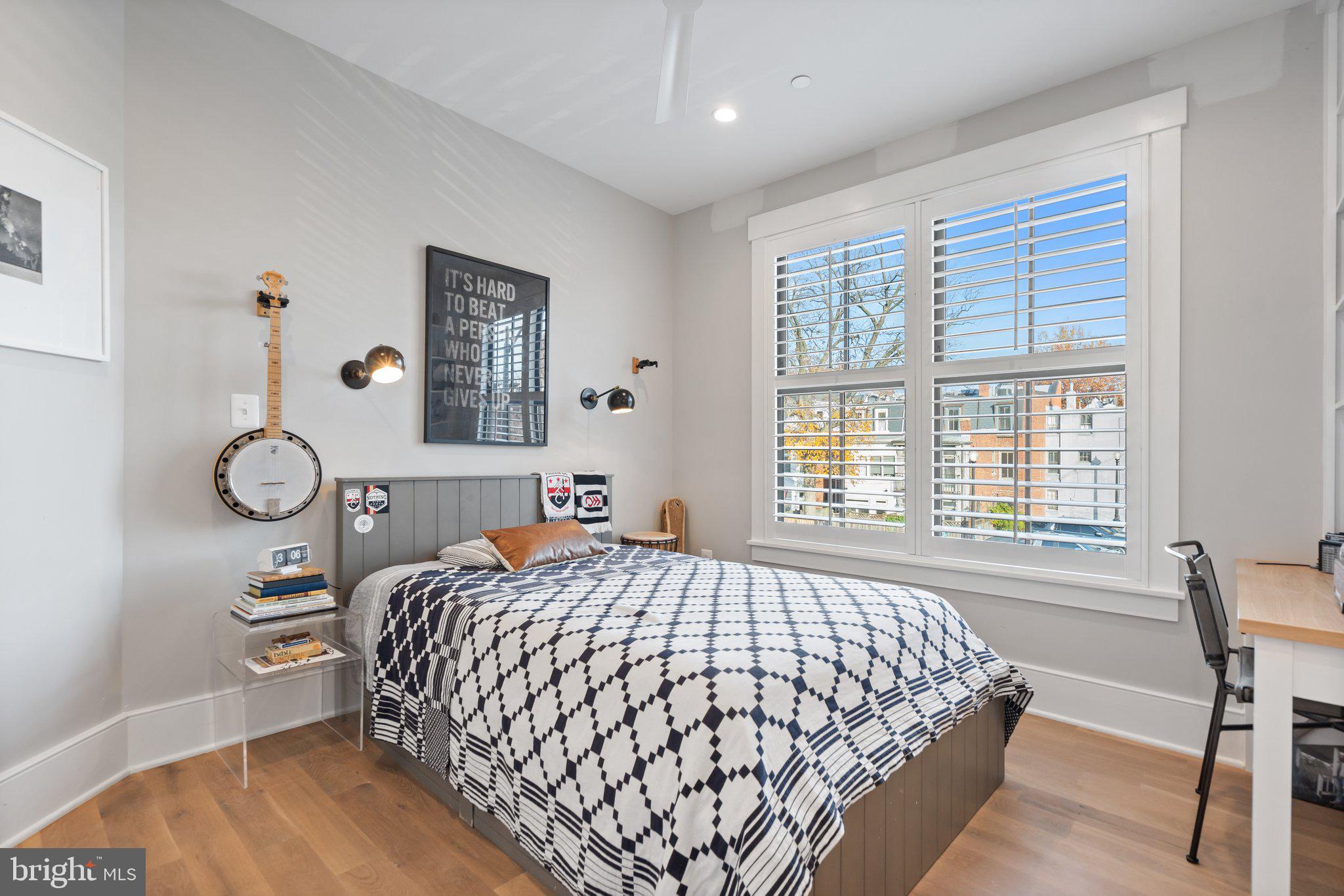 214 A Street Northeast Washington, DC 20002 - Photo 40 of 78 a bedroom with a large bed and a table in it with window