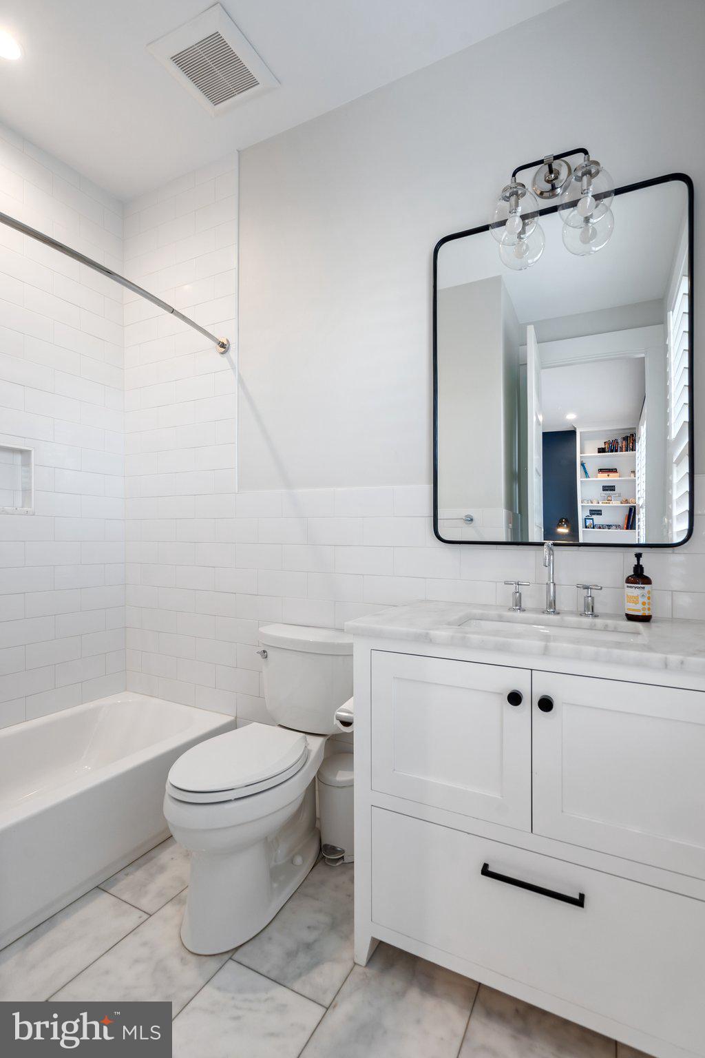 214 A Street Northeast Washington, DC 20002 - Photo 44 of 78 a bathroom with a toilet a sink and mirror