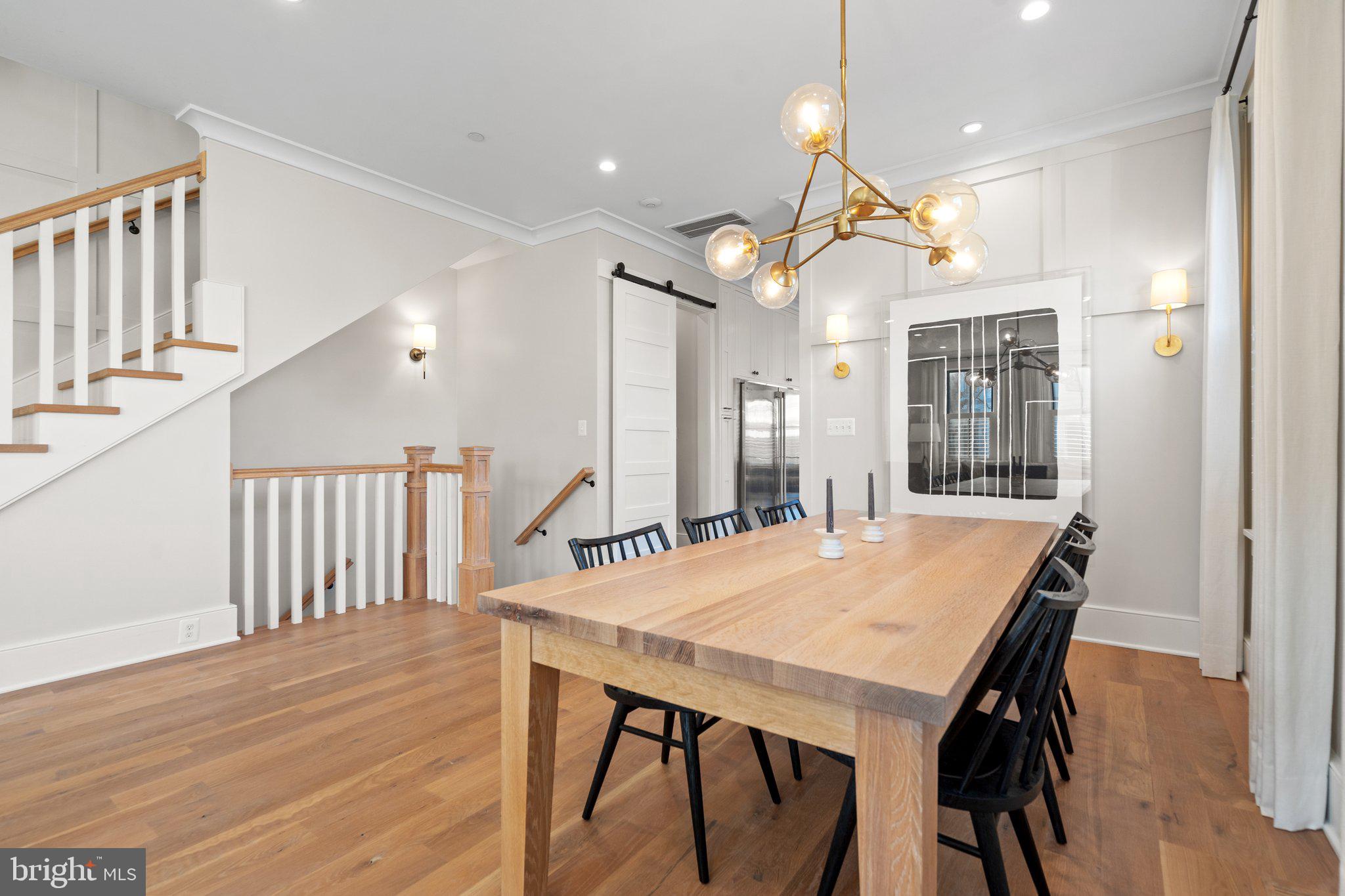 214 A Street Northeast Washington, DC 20002 - Photo 10 of 78 a dining room with wooden floor a chandelier a wooden table and chairs