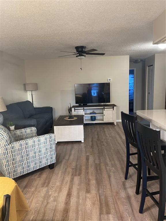 14531 Walsingham Road, Unit 203 Largo, FL 33774 - Photo 7 of 24 a living room with furniture and a flat screen tv