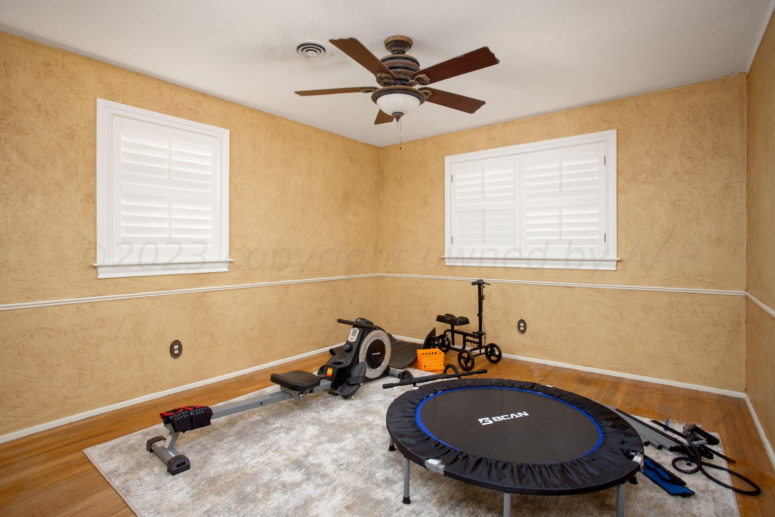 5013 South Bonham Street Amarillo, TX 79110 - Photo 16 of 27 a room with gym equipment and a window