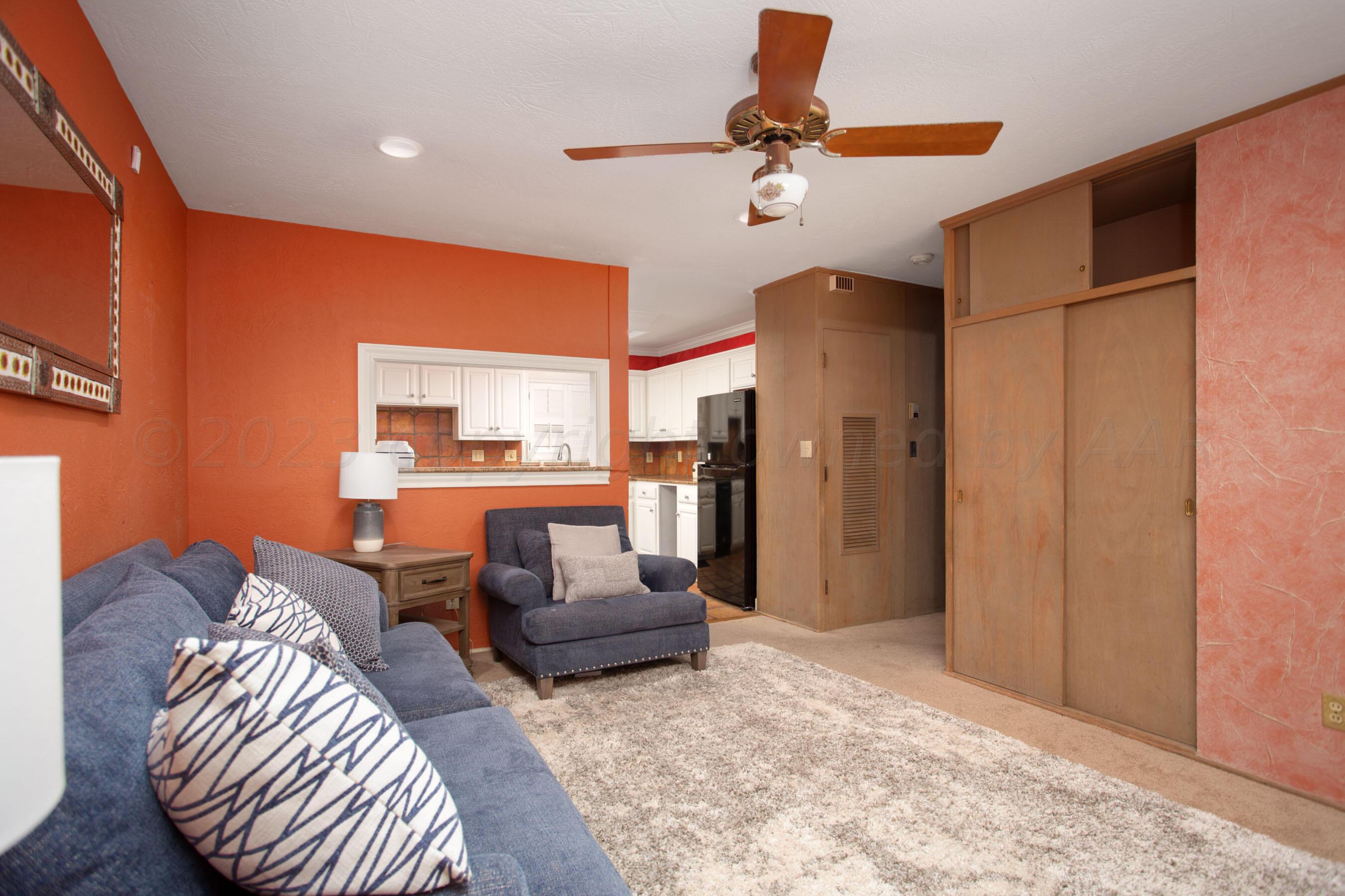 5013 South Bonham Street Amarillo, TX 79110 - Photo 5 of 27 a living room with furniture and a chandelier