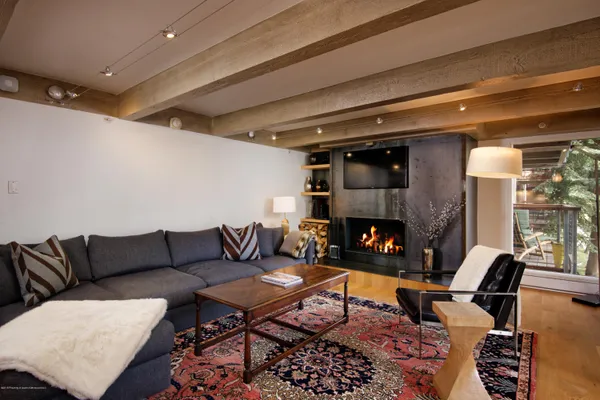 a living room with furniture a rug and a fireplace