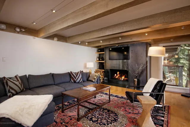 a living room with furniture a rug and a fireplace