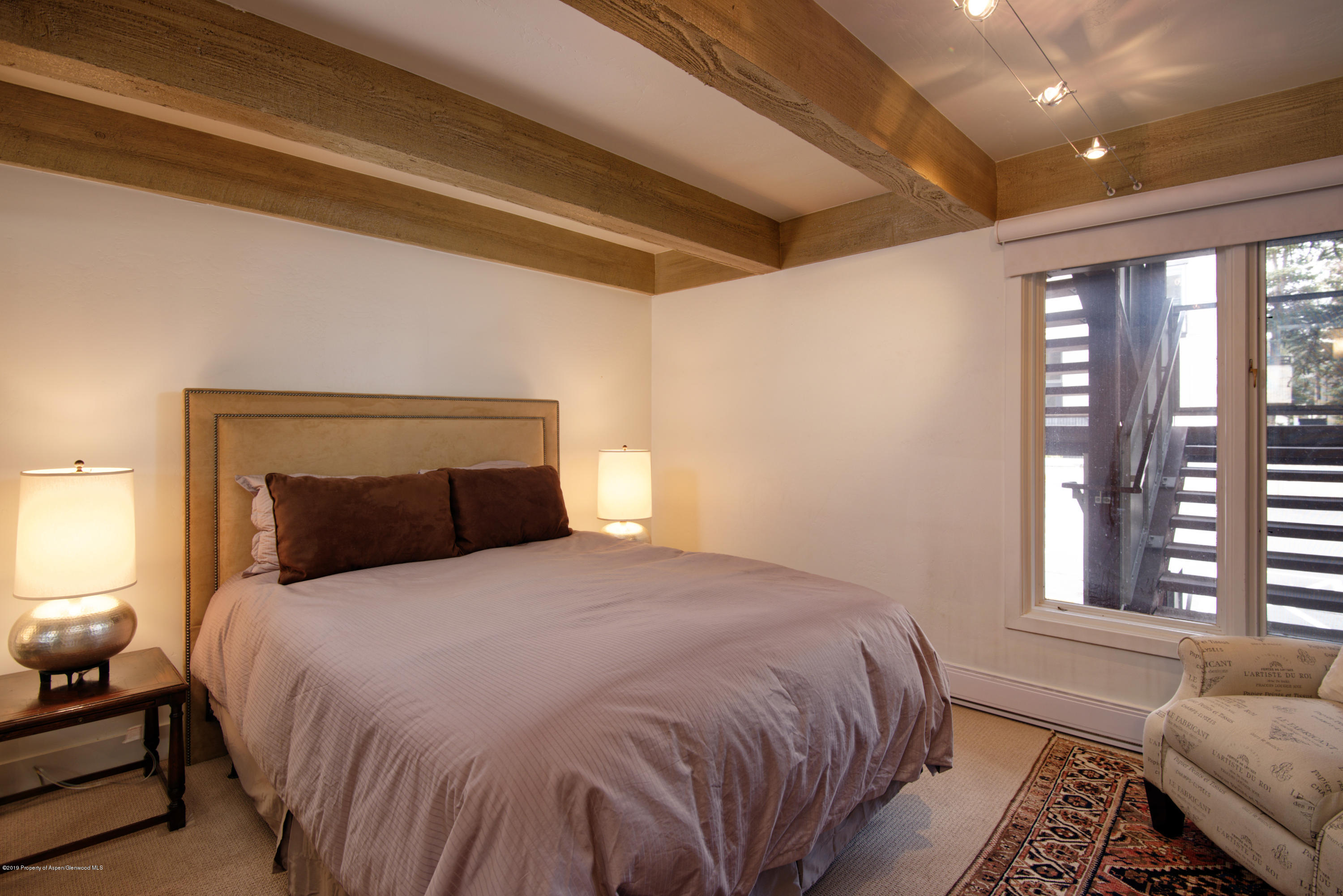 1034 East Cooper Avenue, Unit 5A Aspen, CO 81611 - Photo 6 of 15 a bedroom with a large bed and a window