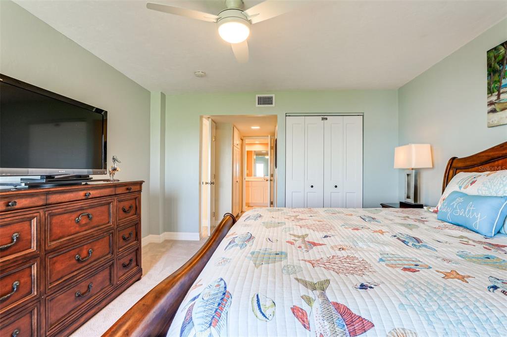 2955 North Beach Road, Unit A432 Englewood, FL 34223 - Photo 11 of 24 a bedroom with a bed and a flat screen tv