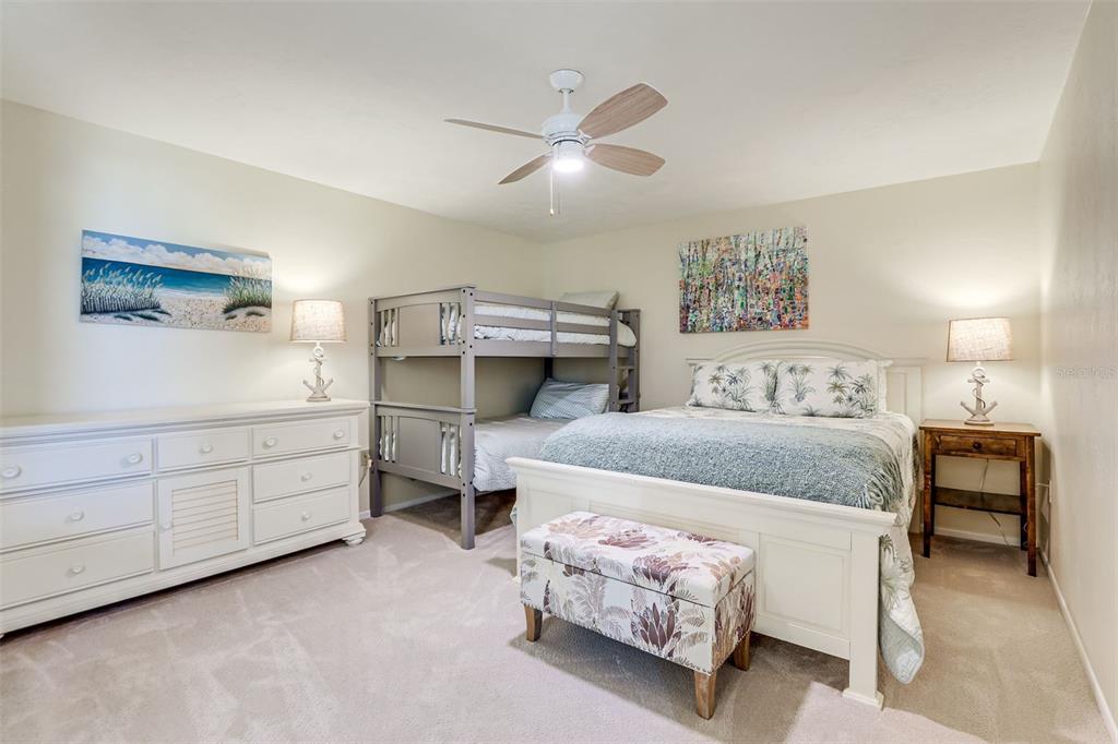 2955 North Beach Road, Unit A432 Englewood, FL 34223 - Photo 14 of 24 a bedroom with a bed and a chandelier