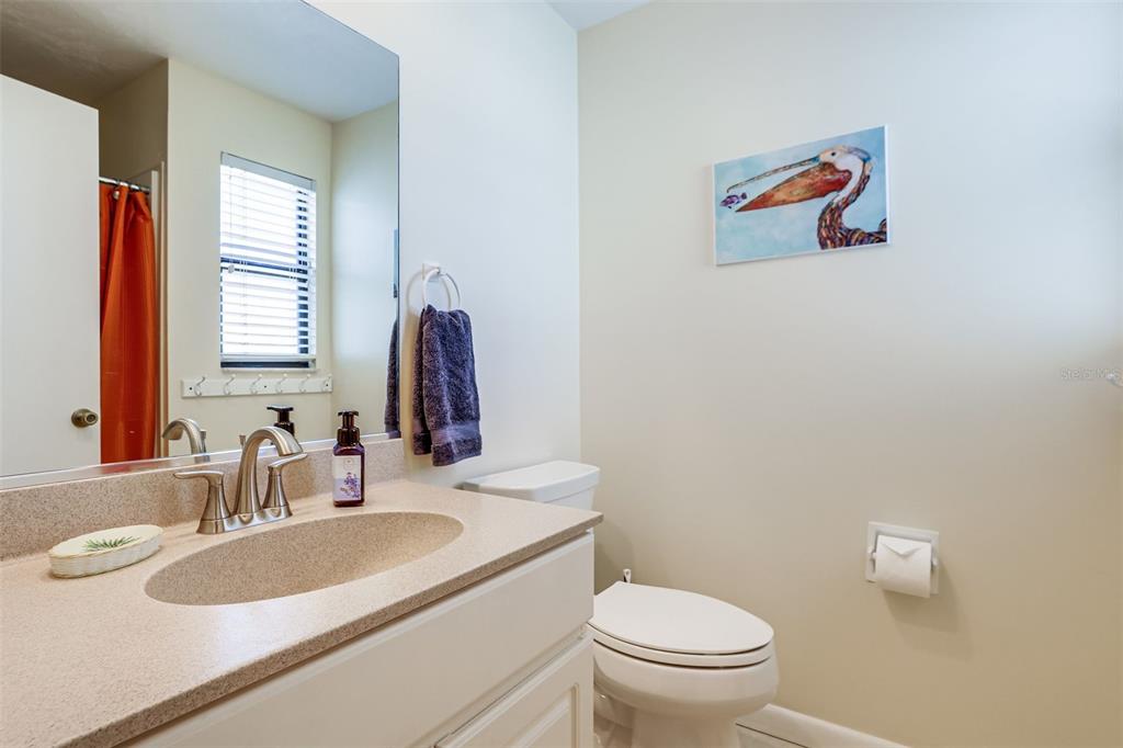 2955 North Beach Road, Unit A432 Englewood, FL 34223 - Photo 16 of 24 a bathroom with a sink vanity mirror and toilet