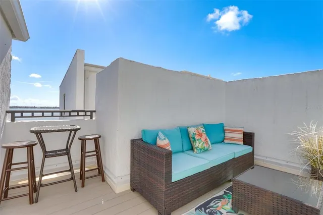 a living room with furniture a flat screen tv and a table