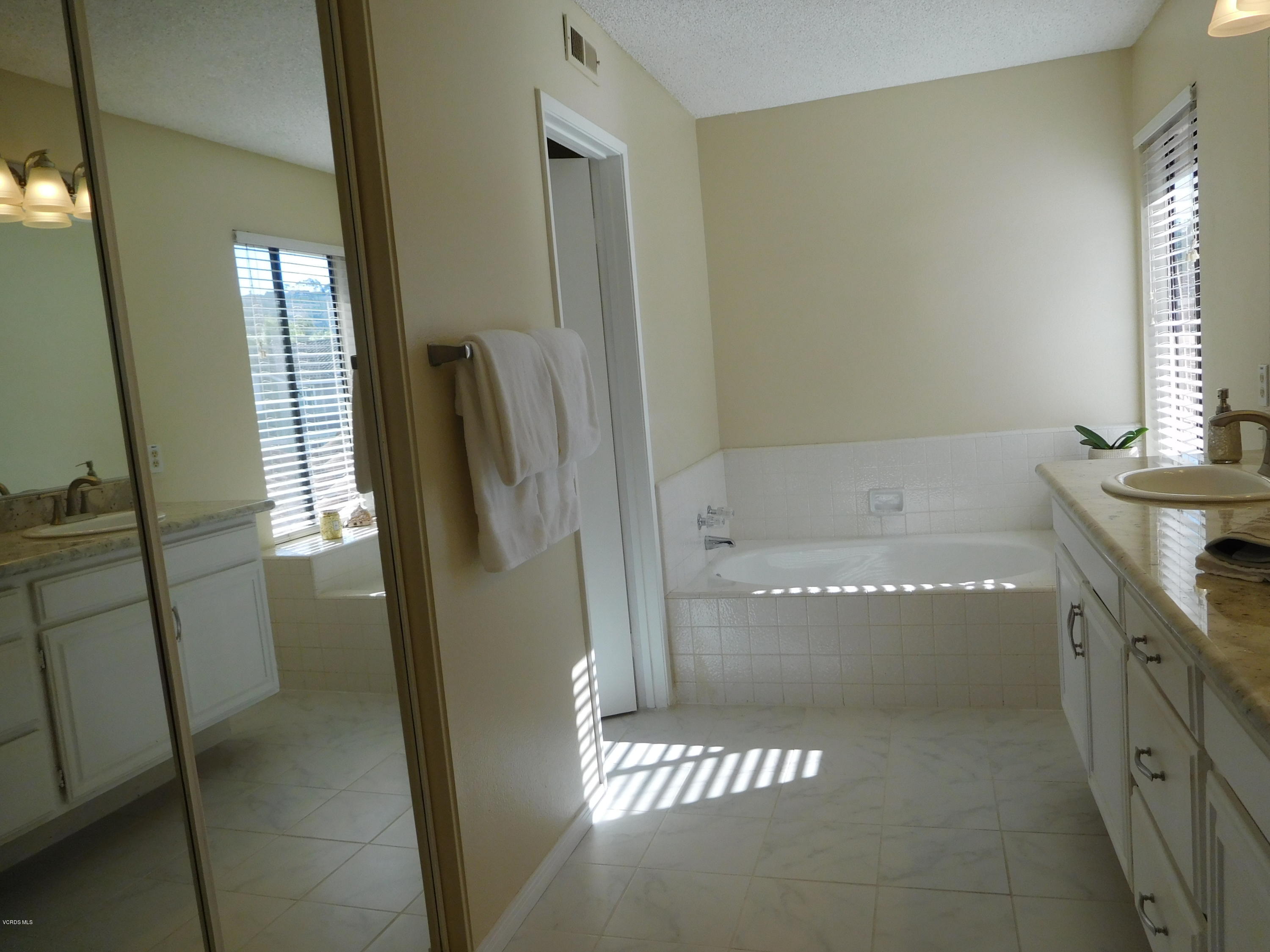 12531 Spring Creek Road Moorpark, CA 93021 - Photo 22 of 30 a bathroom with a tub and a sink