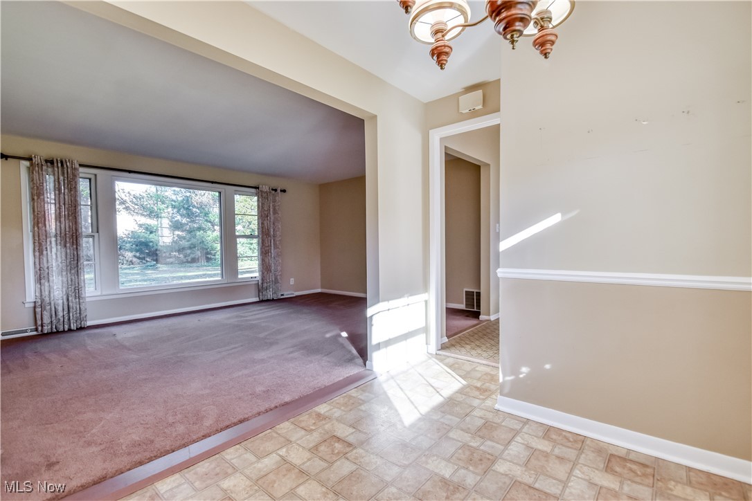 6145 Hemingway Road Cleveland, OH 44143 - Photo 9 of 50 Spare room featuring light colored carpet and a chandelier