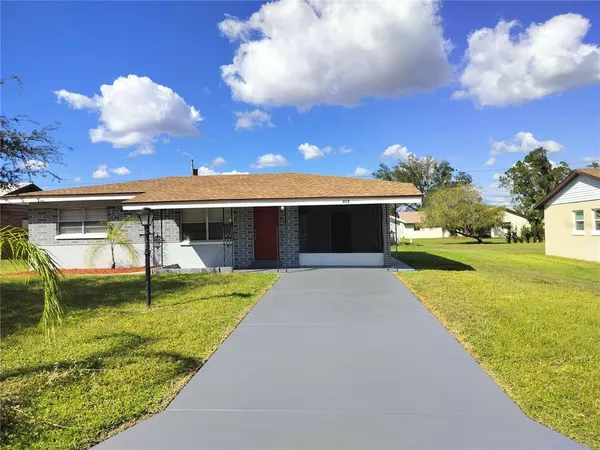 a view of a house with swimming pool and a yard