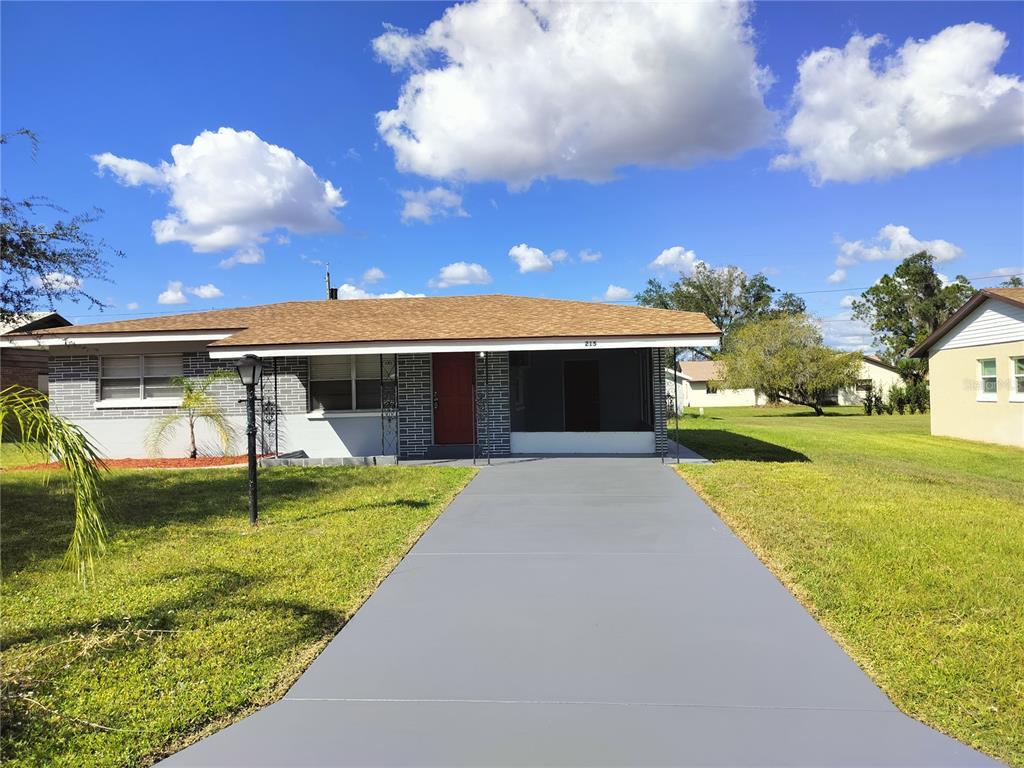 a view of a house with swimming pool and a yard