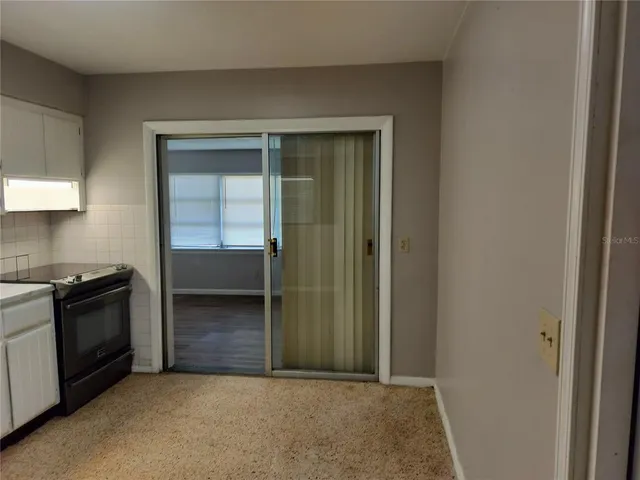 an empty room with kitchen and a sink
