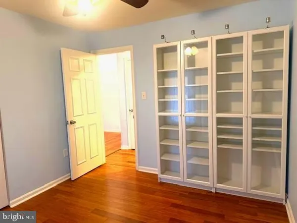a view of wooden floor and windows in a room