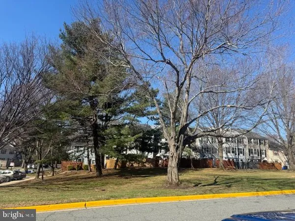 a view of a house with large trees