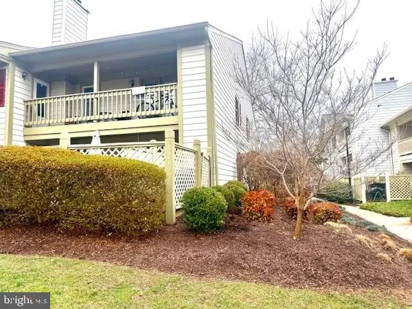 a yellow house with trees in front of it